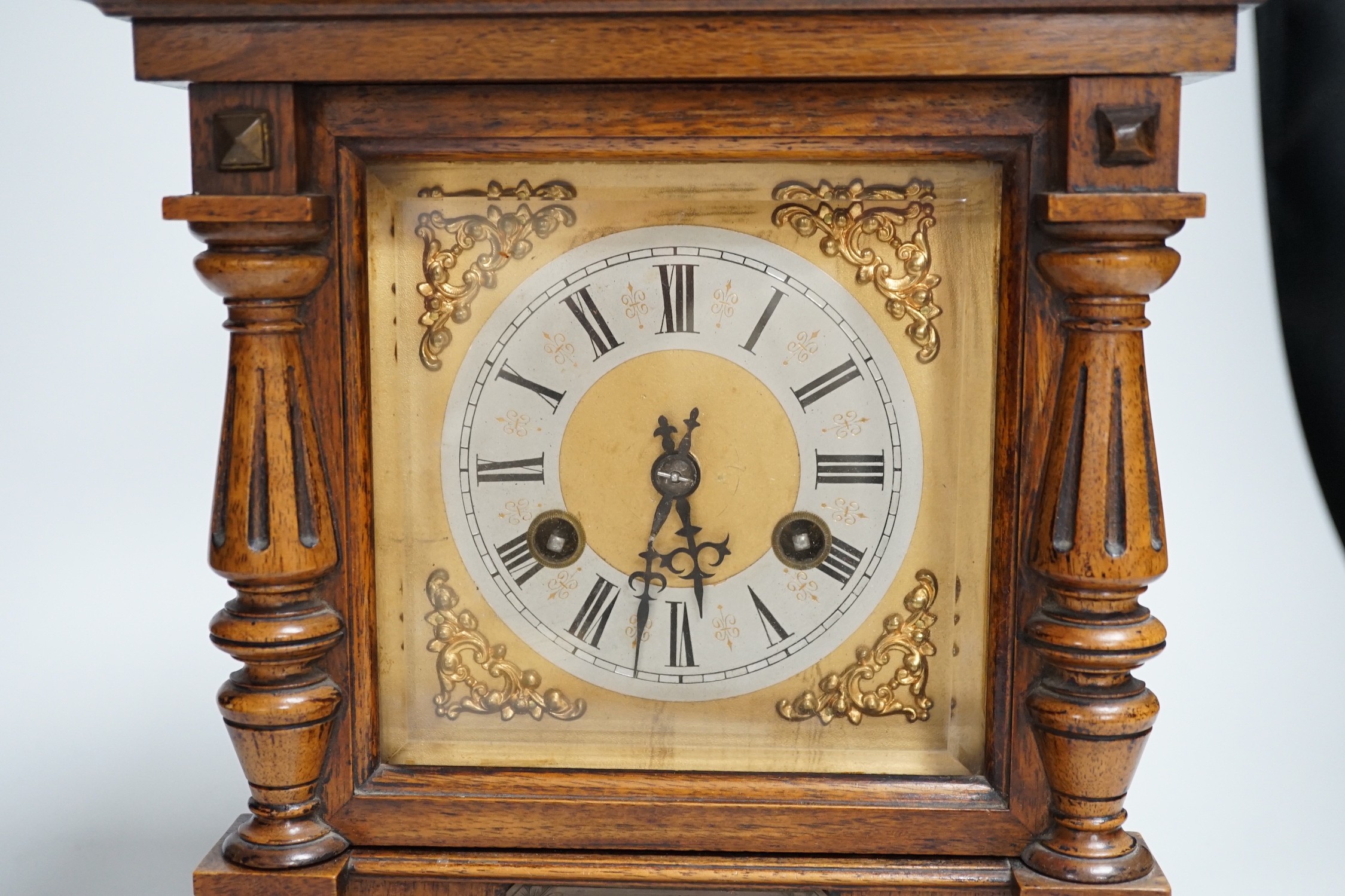 A German oak cased clock, plaque reads ‘Presented to Harry Collins on the occasion of his marriage by the members of Bradford House May 1st 1897’. Height 40cm